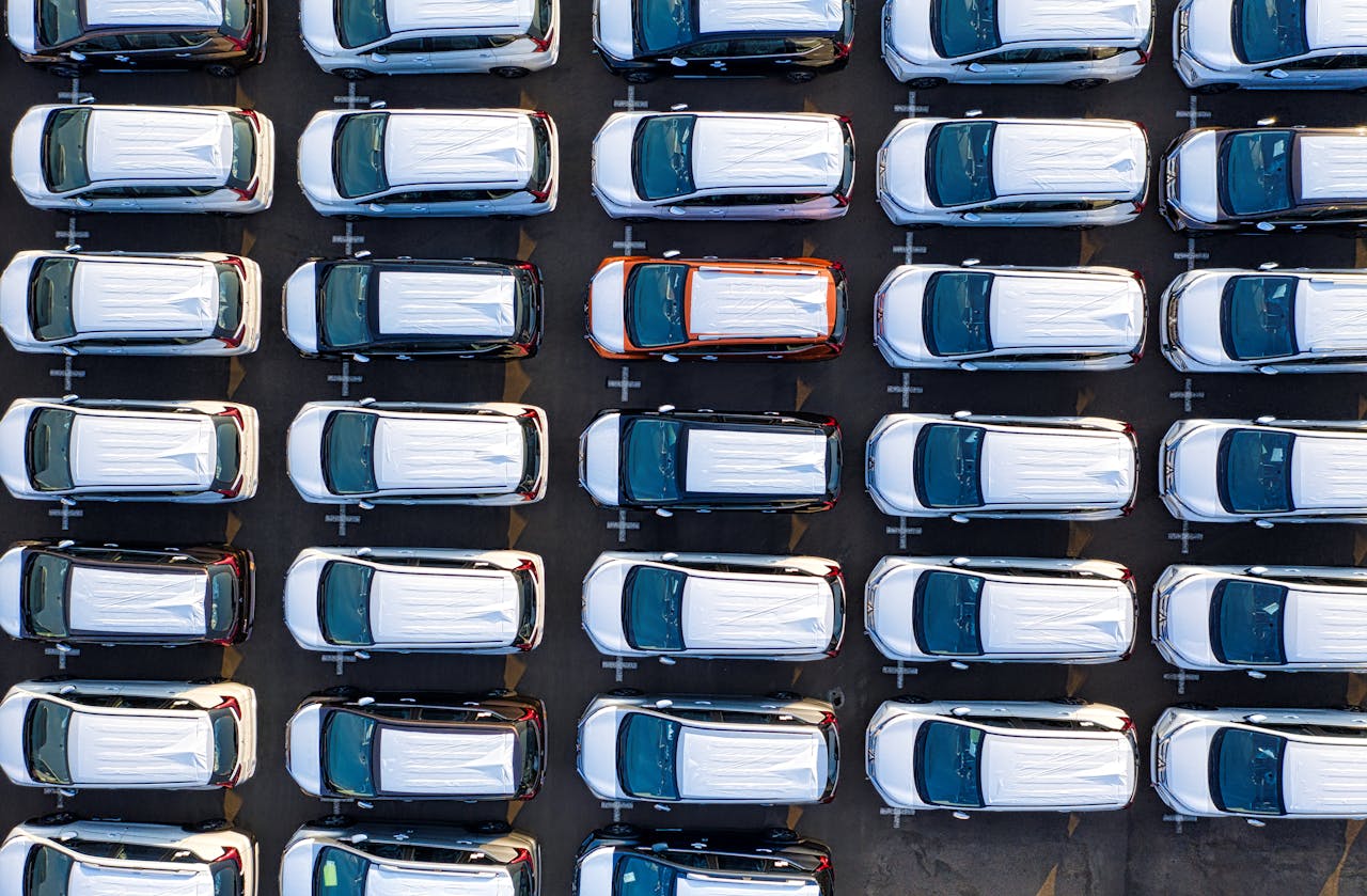Drone view of contemporary expensive many rows of automobiles of manufacture in daytime